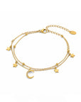 Gold bracelet with star and moon charms on a white background