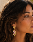 Close-up of a woman wearing floral earrings outdoors