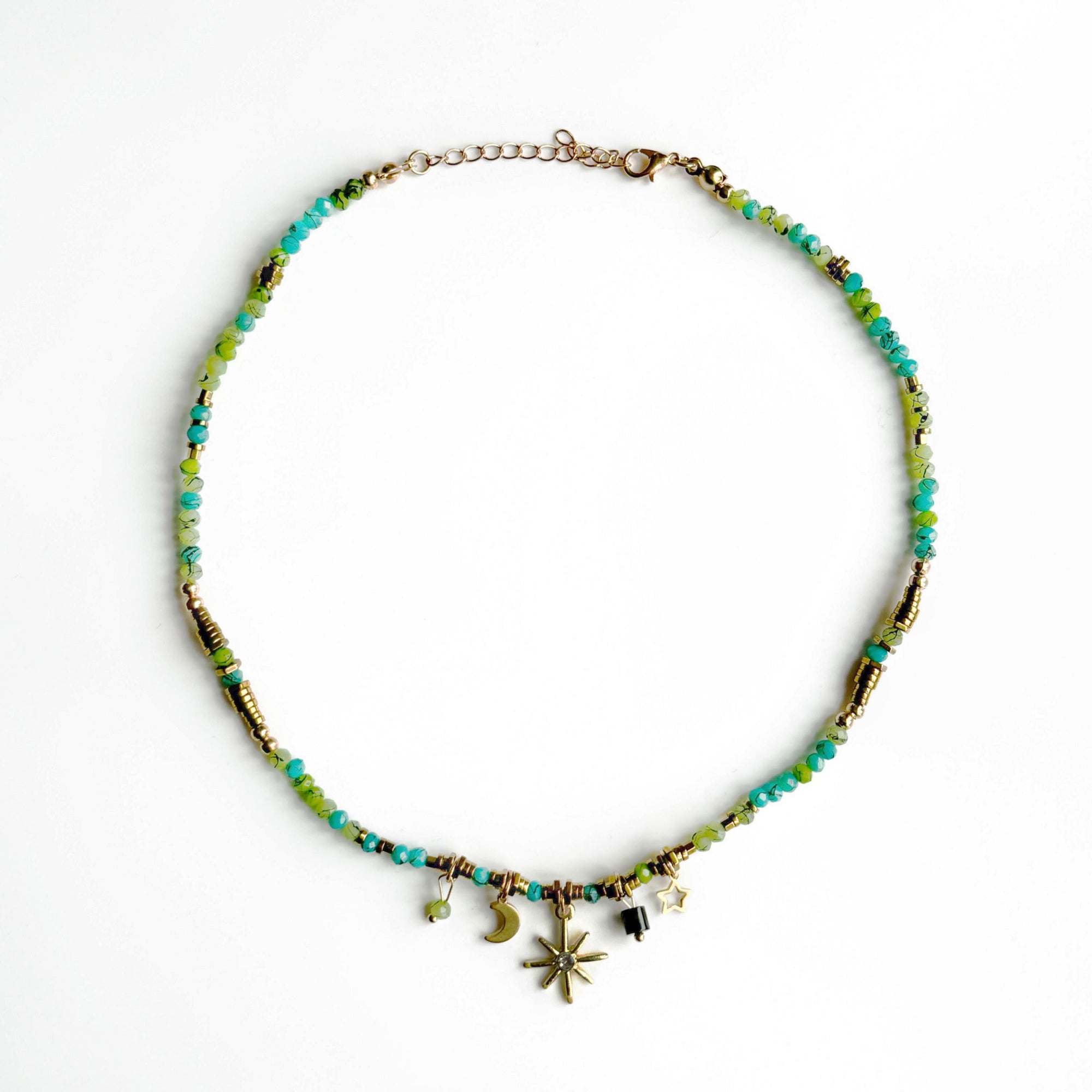 A boho-style choker necklace with multicolored beads, gold-tone beads, and celestial charms.