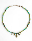 A boho-style choker necklace with multicolored beads, gold-tone beads, and celestial charms.
