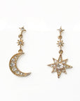 Gold earrings shaped like a moon and a star on a white background