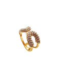 Gold and brown gemstone ring on a white background