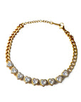 Gold necklace with heart-shaped gemstones on a white background