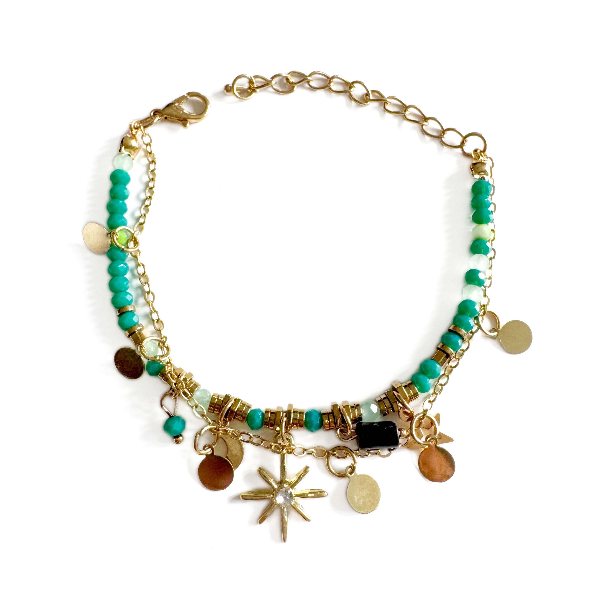 Multicolored beaded bracelet with gold chain and various charms on a white background