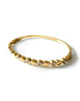 Gold bracelet with small diamonds on a white background