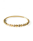 Gold bracelet with small diamonds on a white background