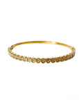 Gold bracelet with small diamonds on a white background