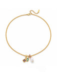 Gold bracelet with charms on a white background