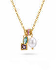 Gold necklace with a pearl pendant and colorful gemstones on a white background