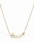 Gold necklace with 'GUR' pendant on a white background