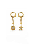 Gold earrings with sun and star charms on a white background