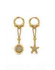 Gold earrings with sun and star charms on a white background