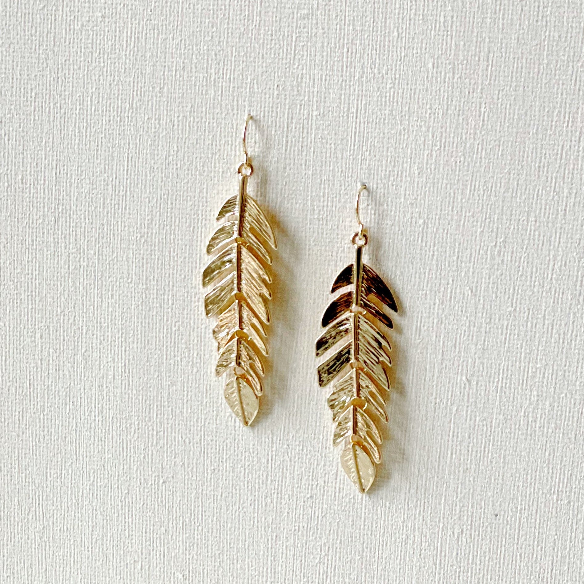 Gold feather drop on sale earrings