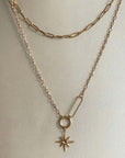 A gold-plated double layer necklace with a star charm pendant, displayed on a mannequin.