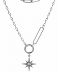 Silver chain necklace with a star-shaped pendant on a white background