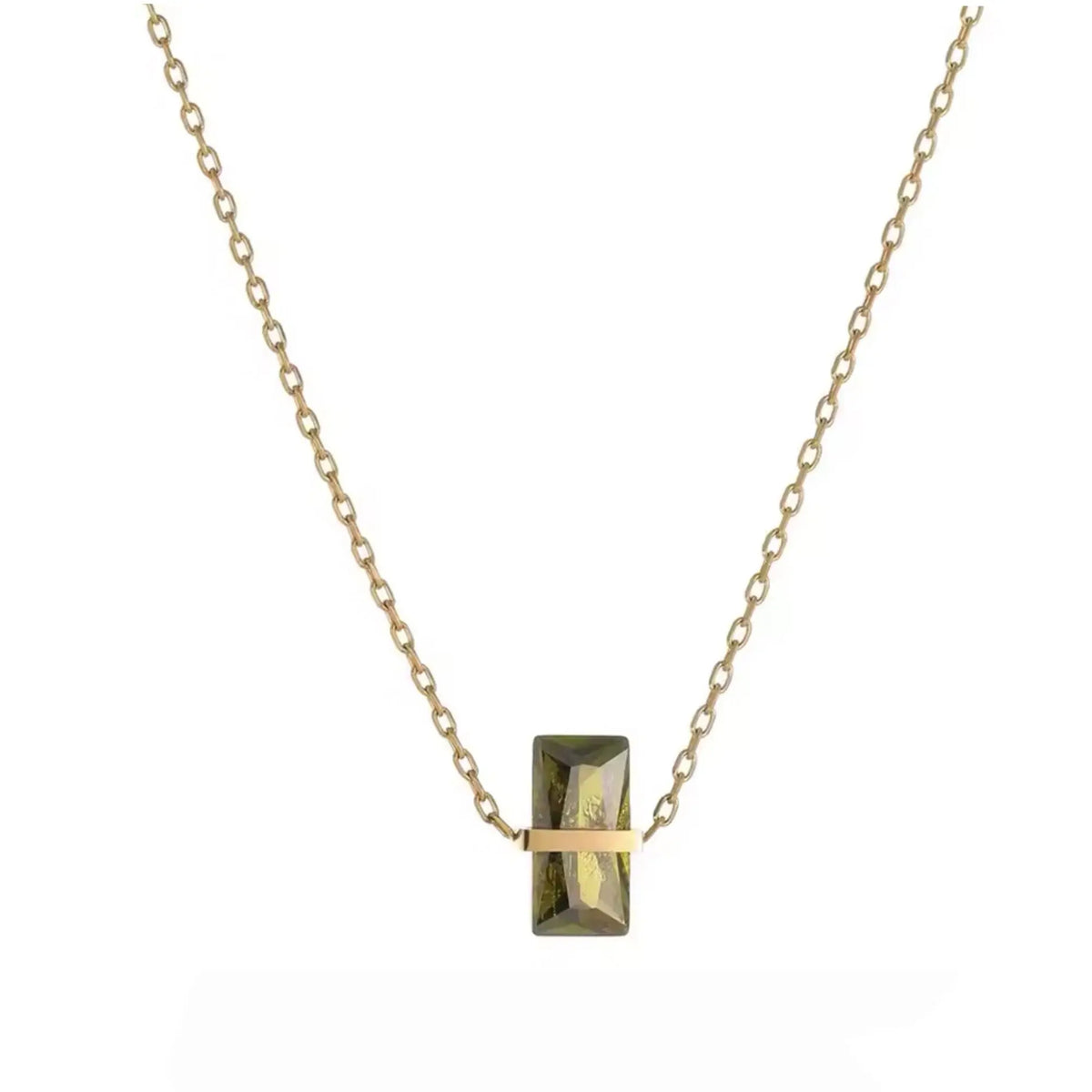 A delicate gold chain necklace featuring a small, vertically-oriented rectangular pendant with a faceted olive-green center and a polished gold horizontal bar across the middle, set against a solid white background.