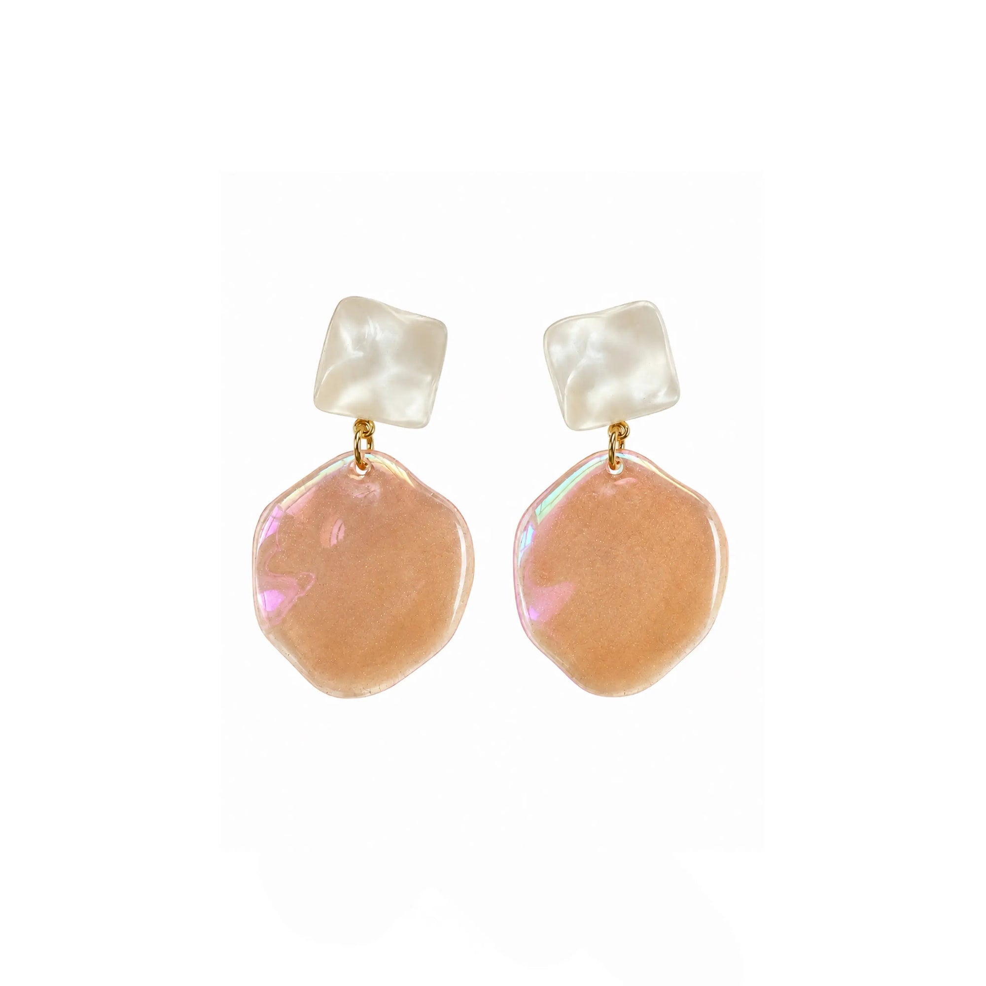 A pair of dangling earrings with iridescent peach-pink irregular disc charms and white square stud tops, connected by small gold rings, shown on a plain white background.