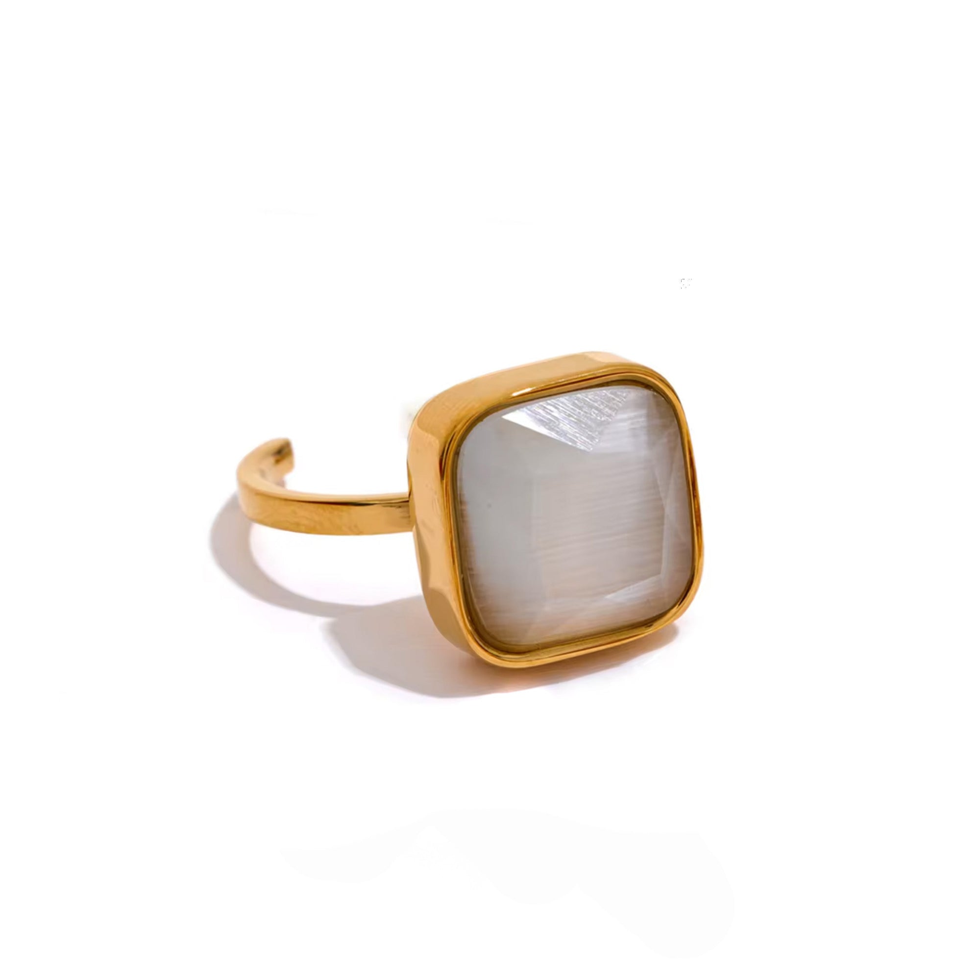 Gold ring with a square stone on a white background