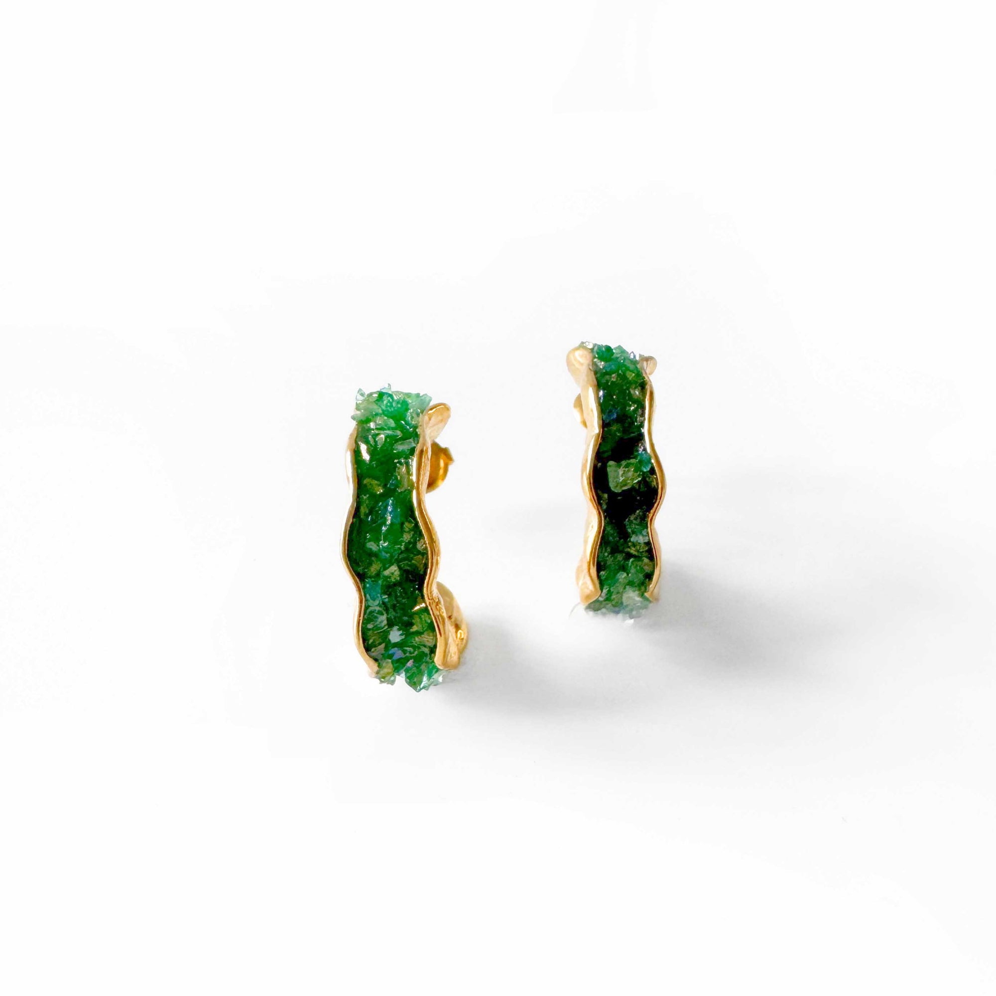 Pair of green stone earrings on a white background