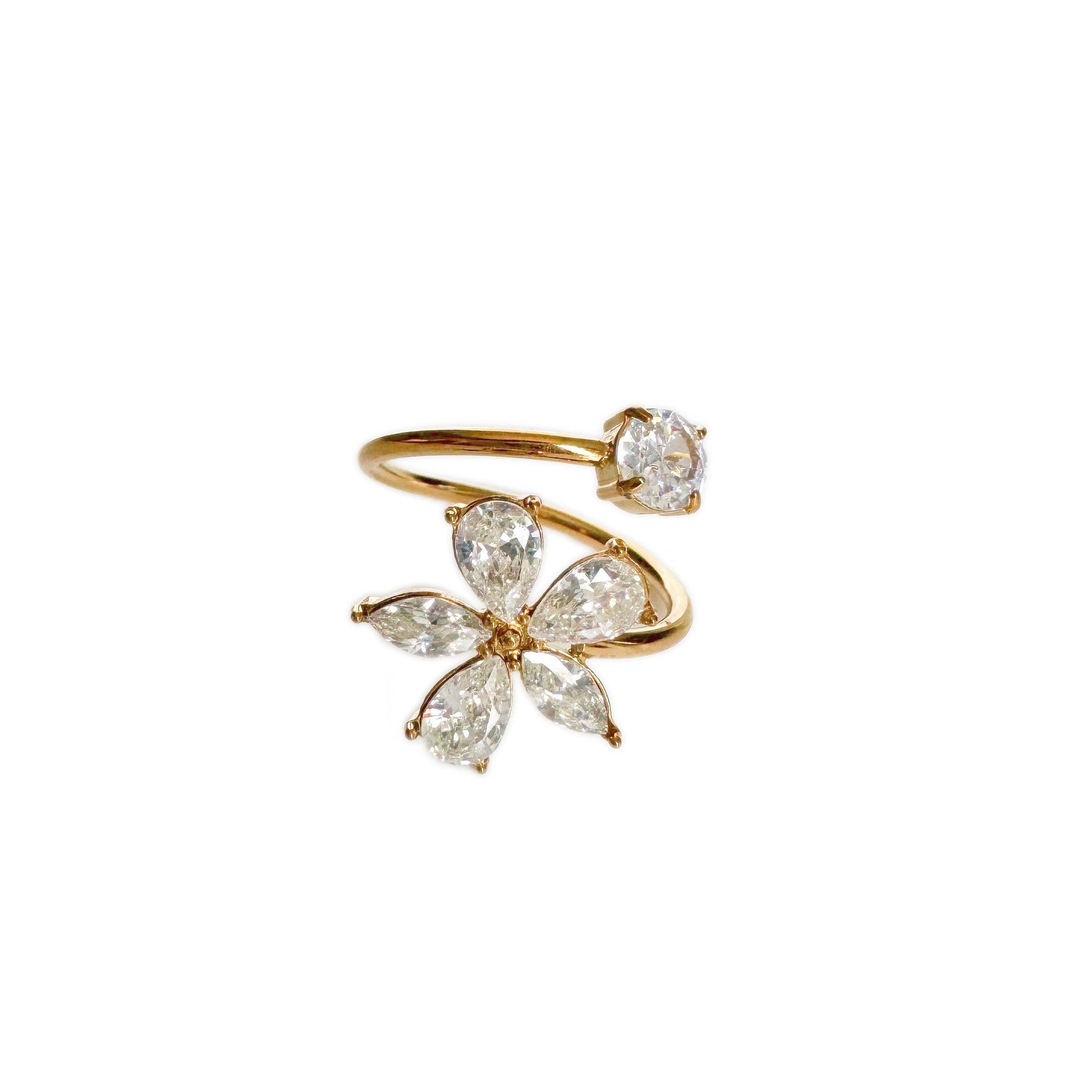 Gold and diamond flower-shaped ring on a white background