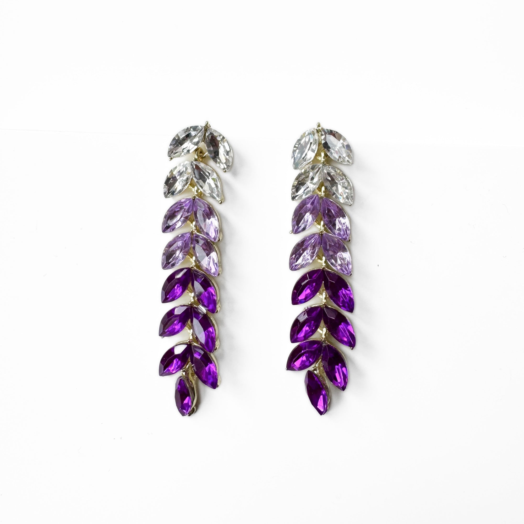 Purple and clear crystal earrings on a white background