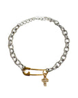 Silver chain bracelet with a gold clasp and cross charm on a white background