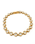 Gold bracelet with clear stones on a white background