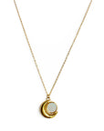 Gold necklace with a circular pendant on a white background
