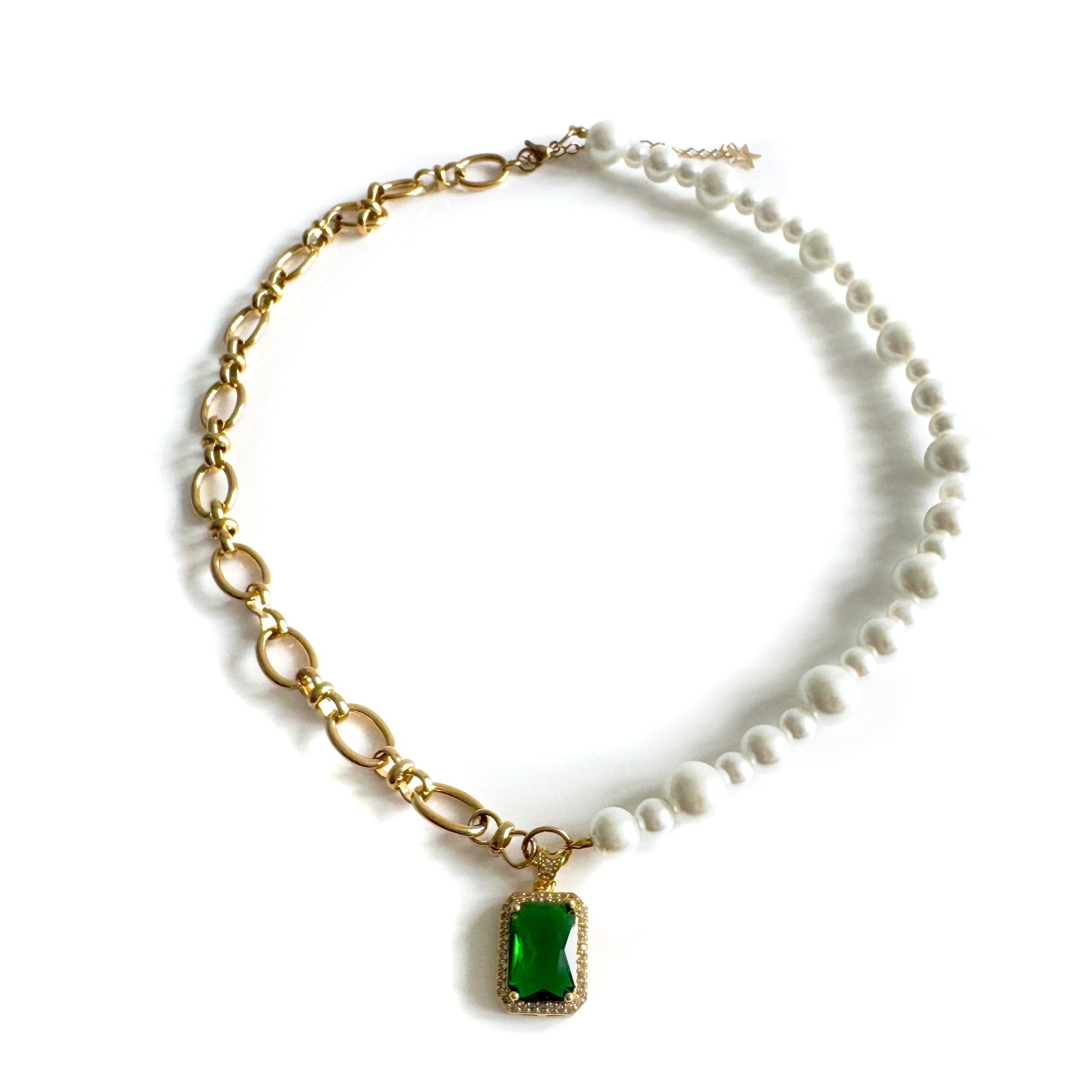 Necklace with gold chain, green gemstone pendant, and pearl accents on a white background