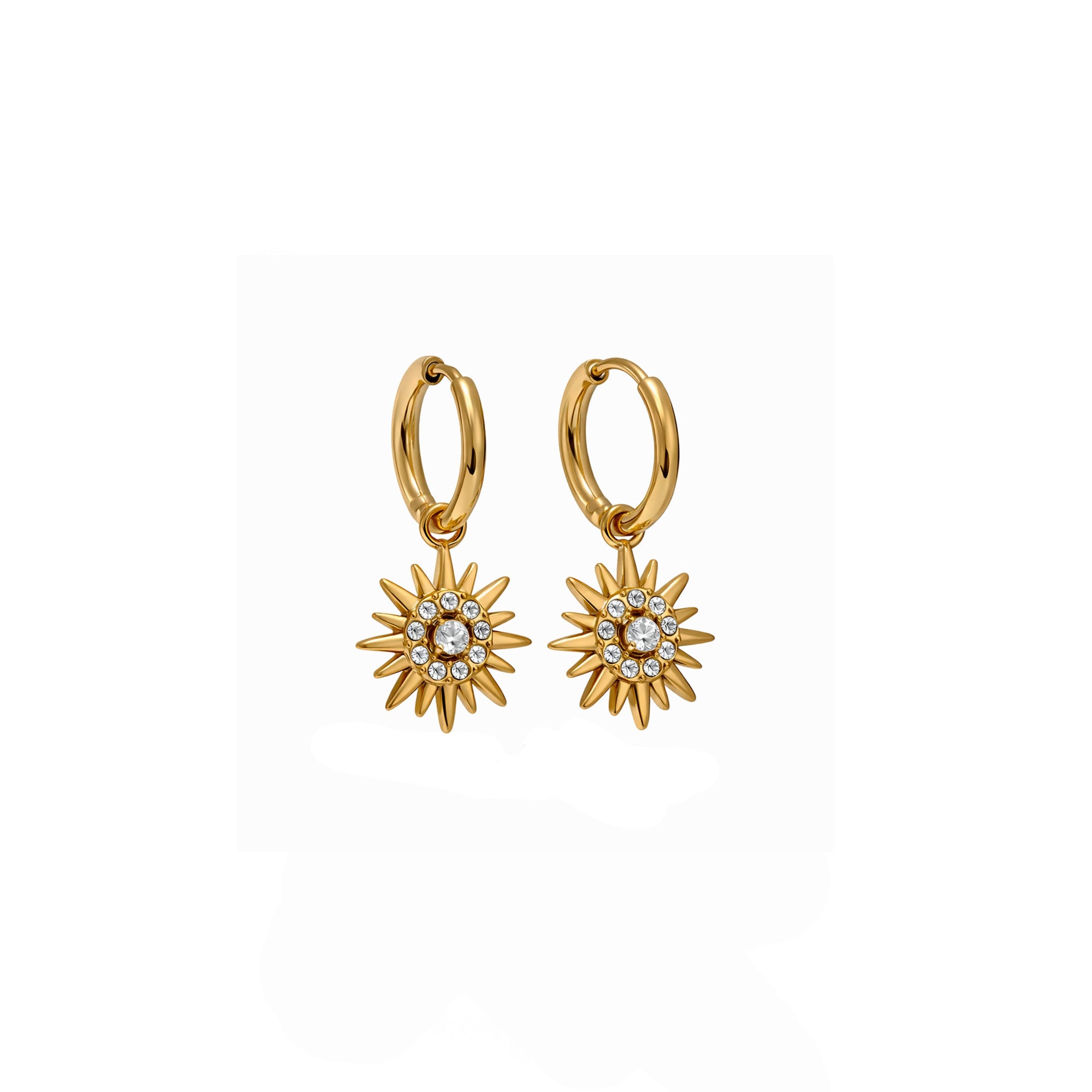 Gold hoop earrings with star-like designs on a white background