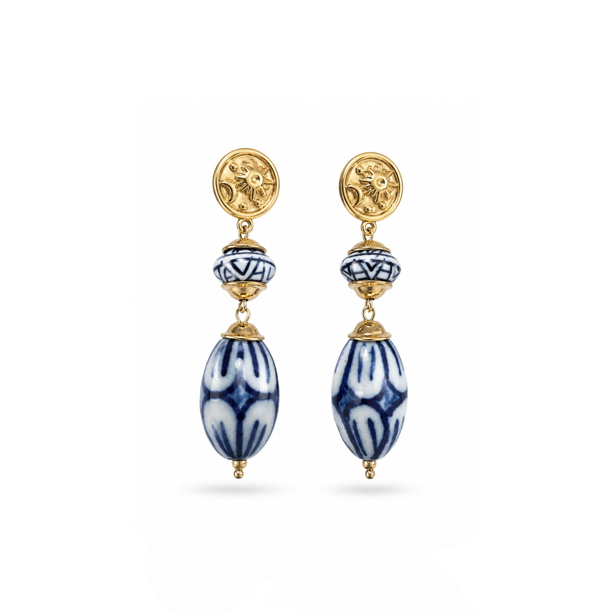 Pair of gold and blue beaded earrings on a white background