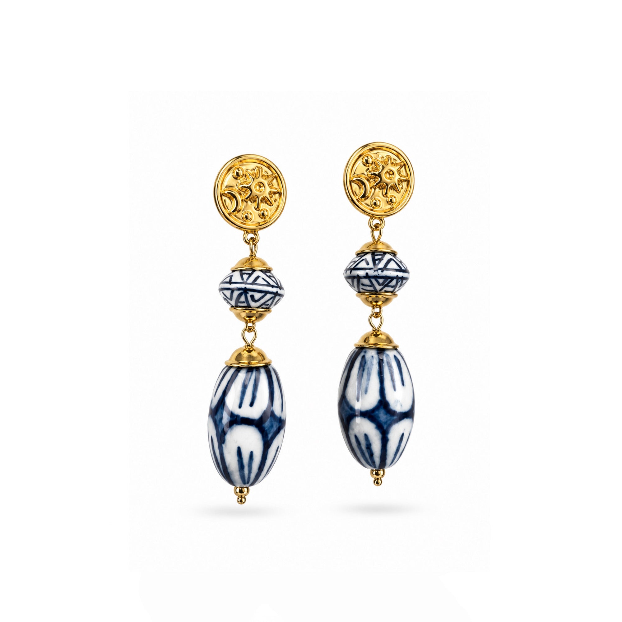 Pair of gold and blue earrings on a white background