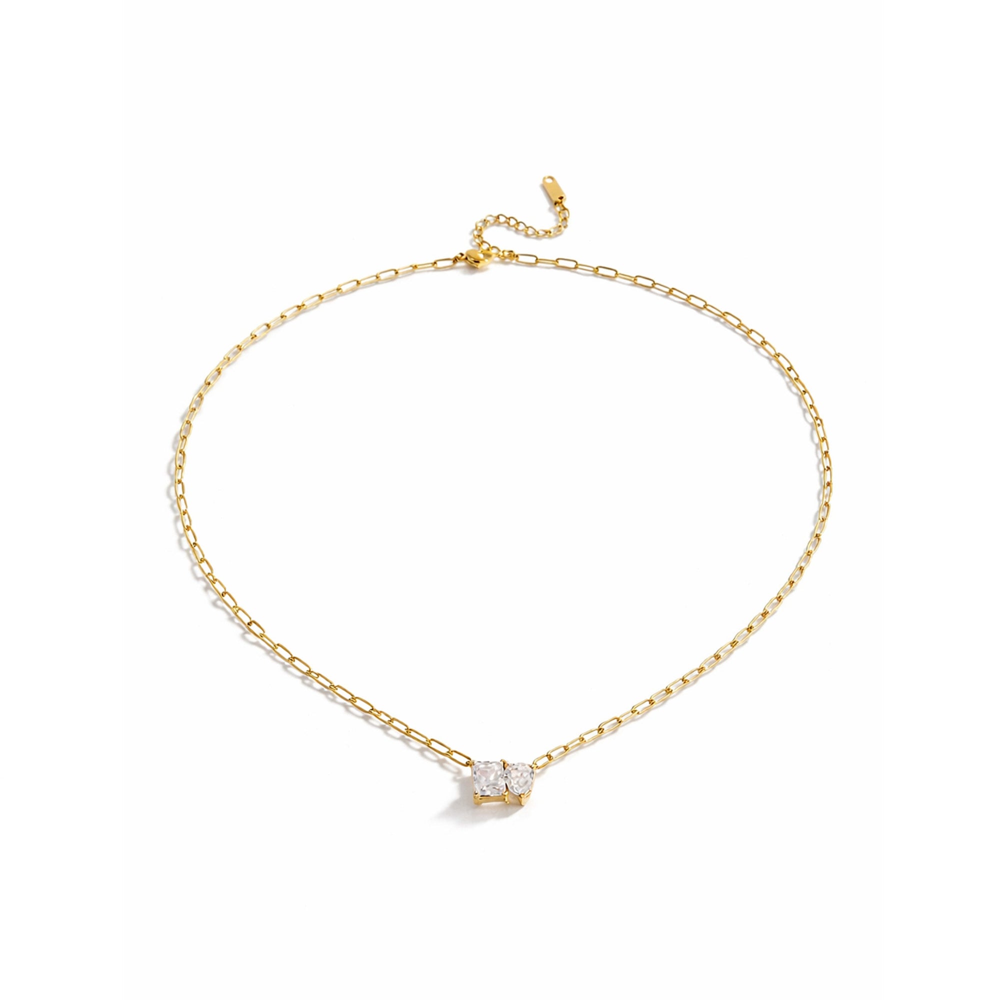 Gold necklace with a small pendant on a white background