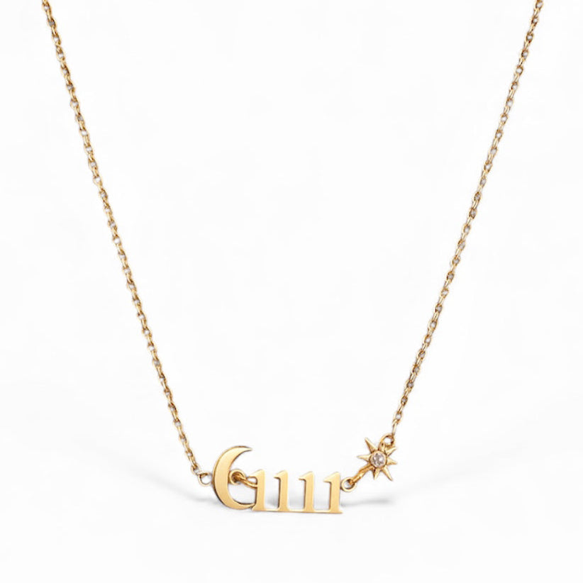 Gold necklace with 'GUR' pendant on a white background