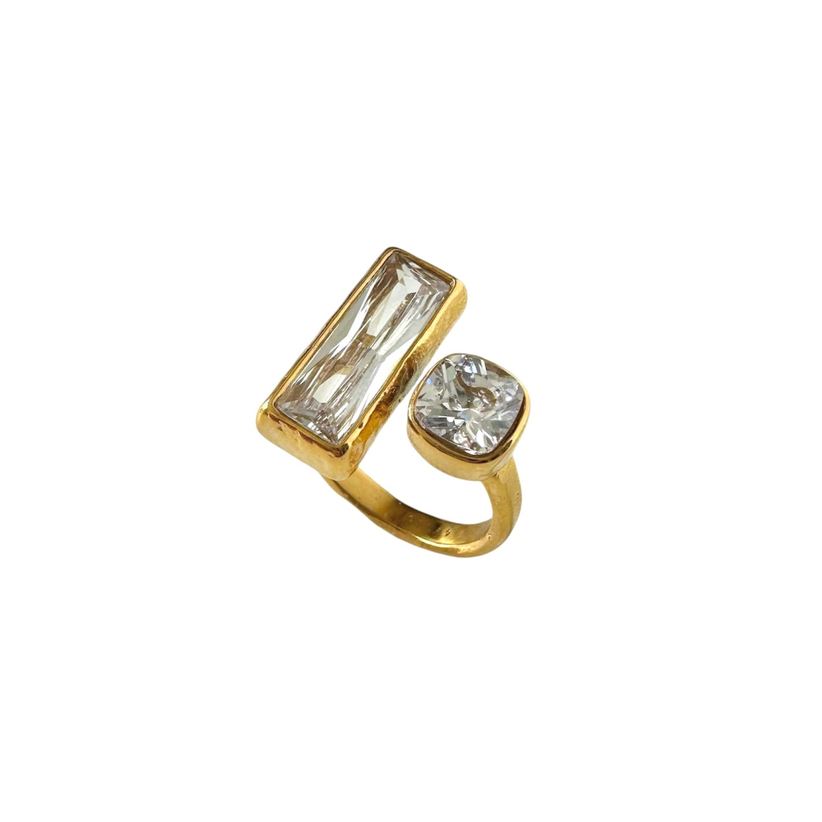 Gold ring with two gemstones on a white background