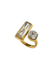 Gold ring with two gemstones on a white background