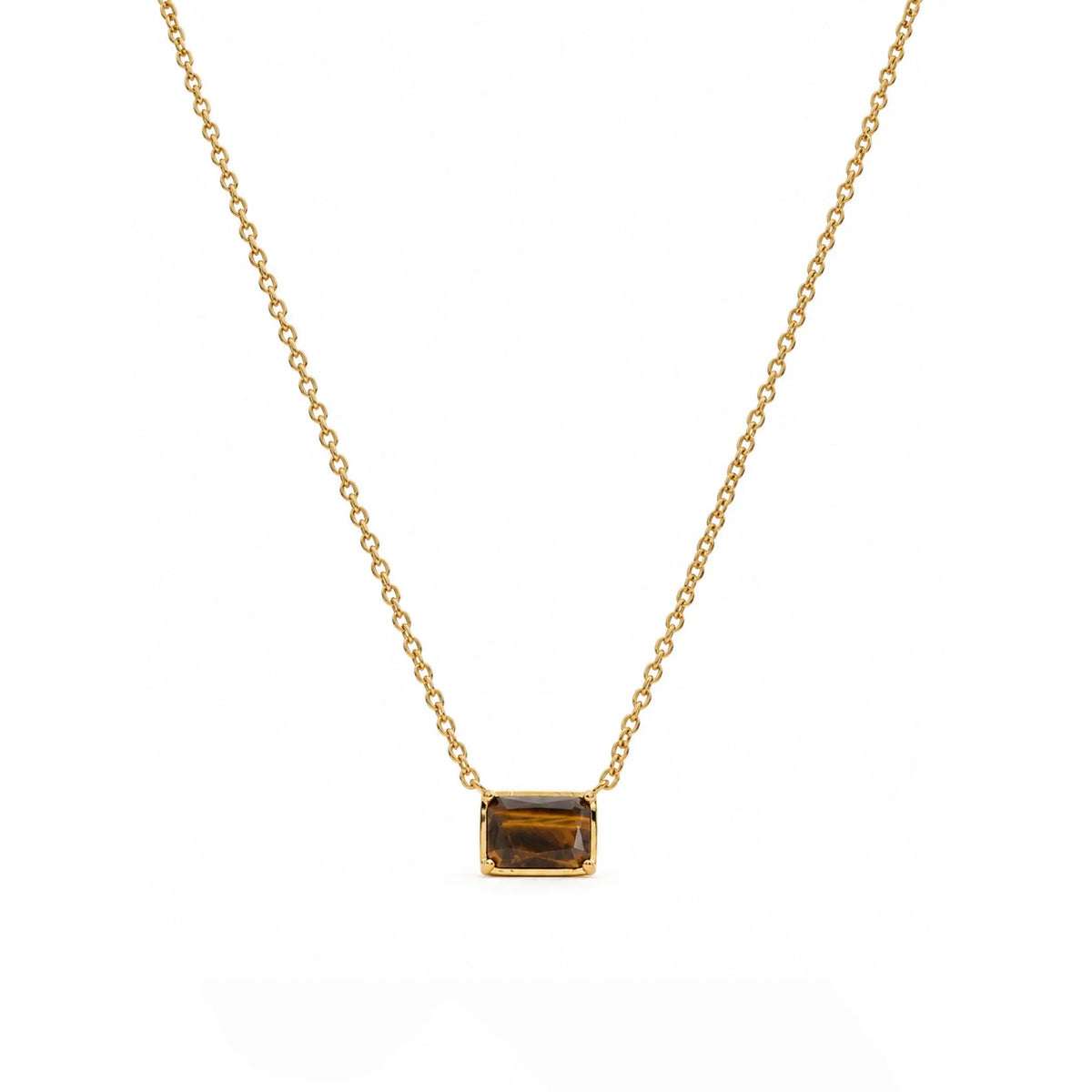 A delicate gold chain necklace with a small rectangular gold pendant featuring a dark brown tiger's eye inlay, displayed against a solid white background.