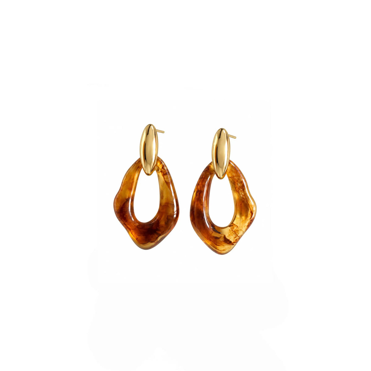 A pair of gold hoop earrings with irregular, organic amber-brown dangling charms, shown on a plain white background.