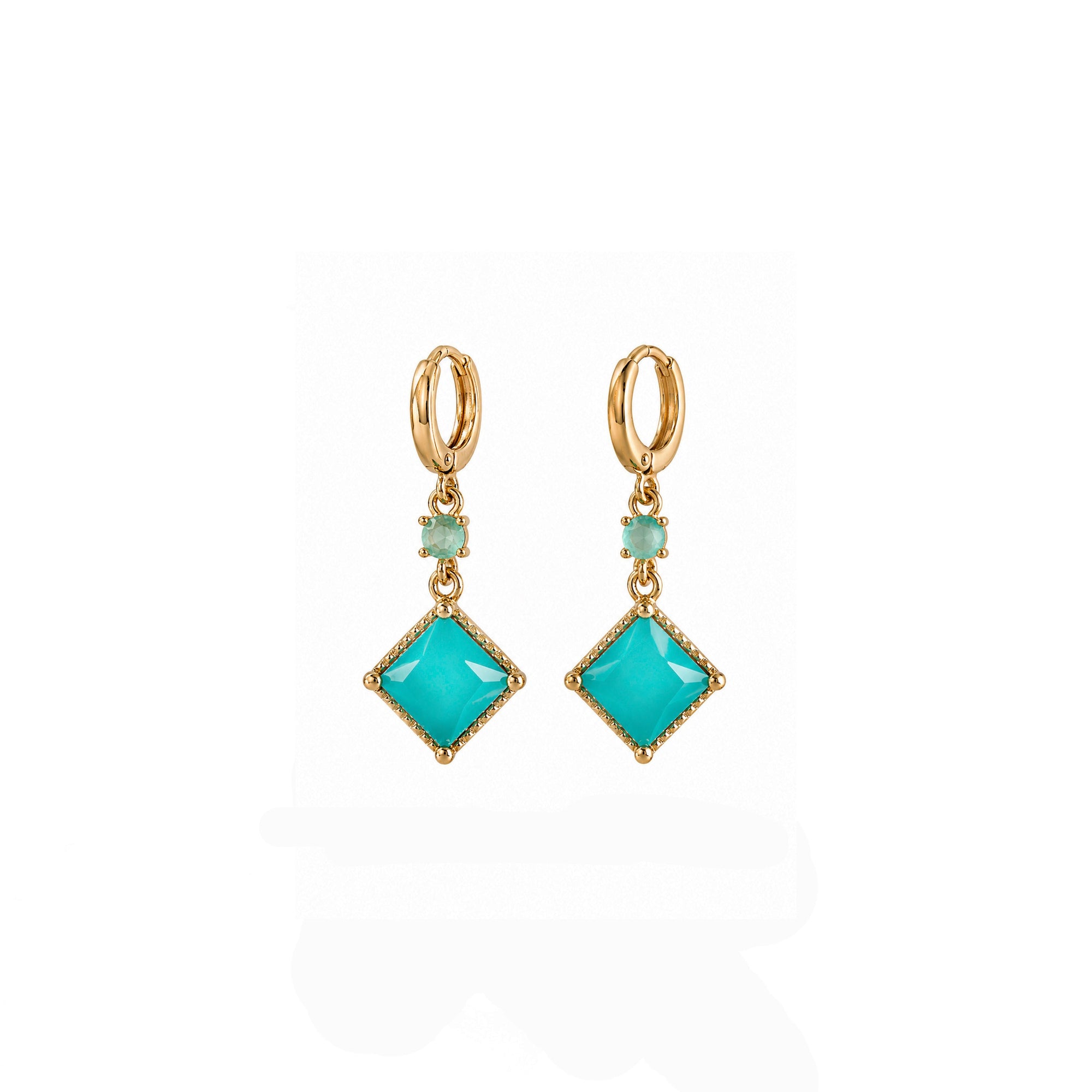 Pair of gold earrings with turquoise gemstones on a white background
